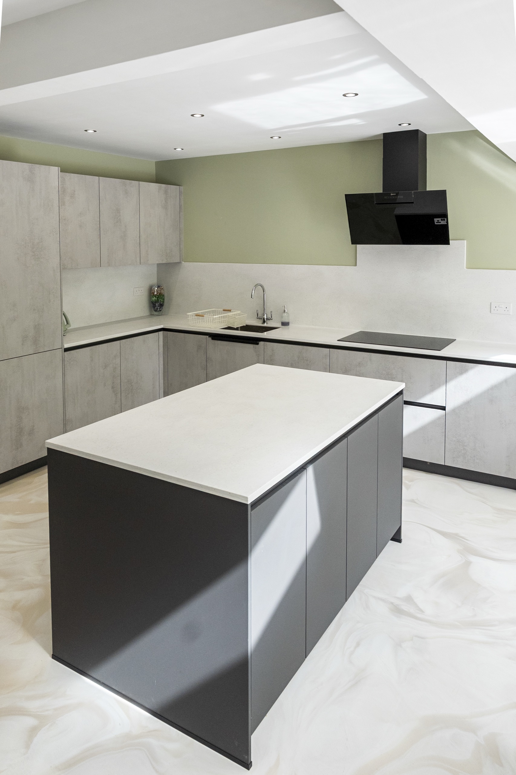 Elba kitchen in Concrete Grey Effect with a dark island and extractor